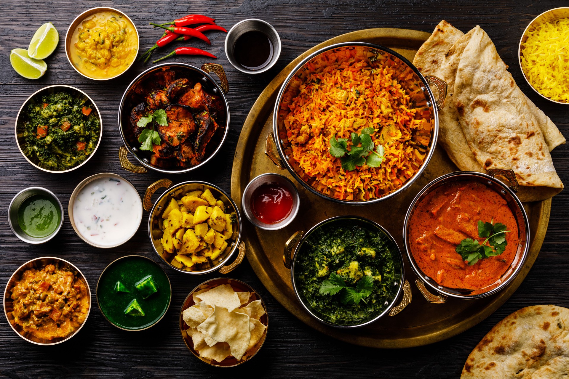 Indian food Curry butter chicken, Palak Paneer, Chiken Tikka, Biryani, Vegetable Curry, Papad, Dal, Palak Sabji, Jira Alu, Rice with Saffron on dark background