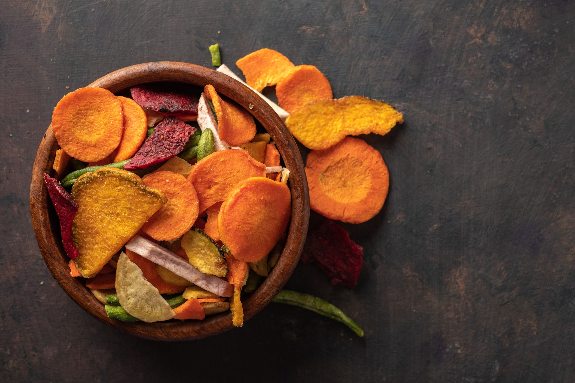 Dried vegetables chips from carrot, beet, parsnip and other vegetables. Organic diet and vegan food.